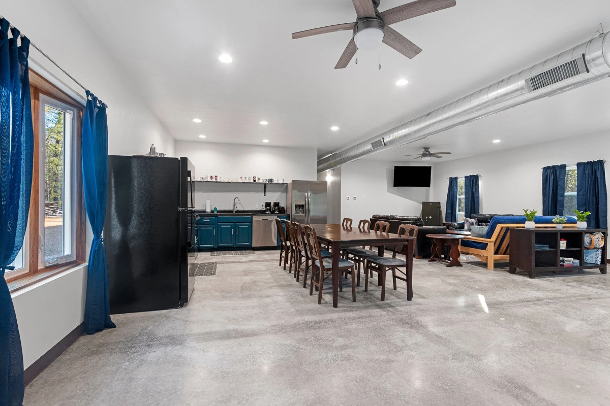larger view of kitchen, dining area, and rec space