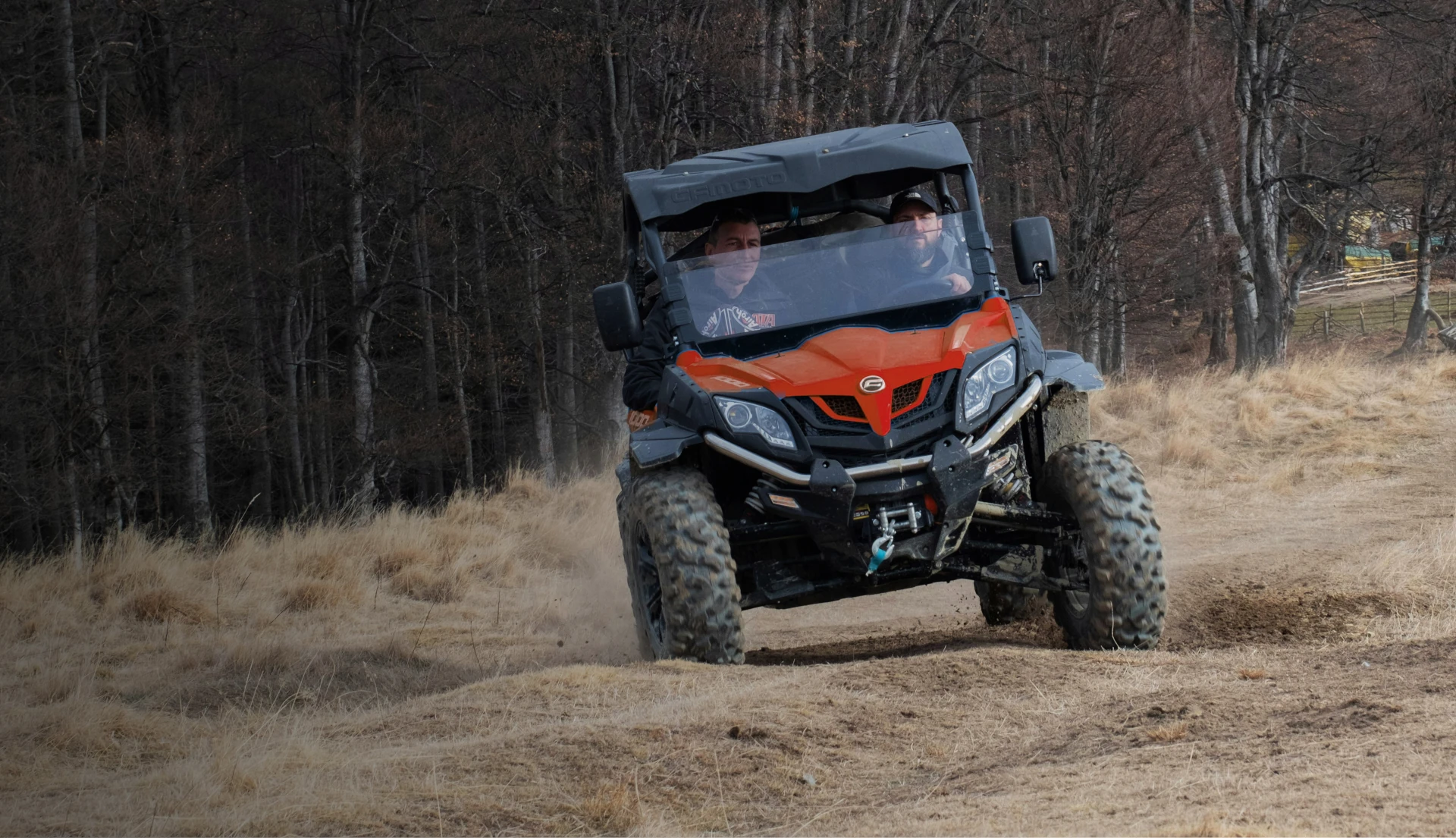 guys driving around a backroad in a UTV